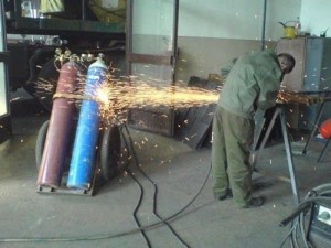 guy welding near tanks